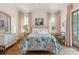 Bright bedroom with floral bedding and hardwood floors at 9004 Topwater Ln, Johns Island, SC 29455