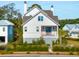 White two story home with dark metal roof and landscaping at 9004 Topwater Ln, Johns Island, SC 29455