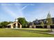 Two modern barn-style buildings with a spacious lawn, showcasing a luxurious estate at 9004 Topwater Ln, Johns Island, SC 29455