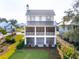 Two story home with screened porch and landscaped yard at 9004 Topwater Ln, Johns Island, SC 29455