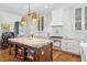 Spacious kitchen with white cabinets, marble island, and professional range at 9004 Topwater Ln, Johns Island, SC 29455