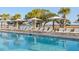 Pool with lounge chairs and umbrellas, overlooking the marsh at 9004 Topwater Ln, Johns Island, SC 29455