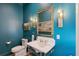 Stylish powder room with teal walls and marble vanity at 9004 Topwater Ln, Johns Island, SC 29455