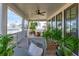 Spacious screened porch features outdoor seating and lush plants at 9004 Topwater Ln, Johns Island, SC 29455