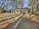 Sun-drenched backyard showcasing a charming brick home at 108 Flicker Ln, Summerville, SC 29485