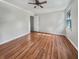 Hardwood floor bedroom with ceiling fan and large window at 108 Flicker Ln, Summerville, SC 29485