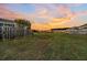 Sunset view of backyard with wooden fence and grassy area at 108 Glenspring Dr, Summerville, SC 29486