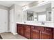 Double vanity bathroom with dark wood cabinets and a large mirror at 108 Glenspring Dr, Summerville, SC 29486