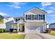 Two-story house with beige siding, black shutters, and a white garage door at 108 Glenspring Dr, Summerville, SC 29486