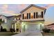 Two-story house with a beige exterior, a white garage door, and a well-manicured lawn at 108 Glenspring Dr, Summerville, SC 29486