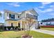 Two-story house with a beige exterior, a white garage door, and a landscaped front yard at 108 Glenspring Dr, Summerville, SC 29486