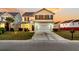 Two-story house with a beige exterior, a white garage door, and a landscaped front yard at 108 Glenspring Dr, Summerville, SC 29486