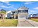 Two-story house with beige siding, black shutters, and a white garage door at 108 Glenspring Dr, Summerville, SC 29486
