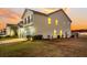 Two-story house with a beige exterior, a white garage door, and a side yard with landscaping at 108 Glenspring Dr, Summerville, SC 29486