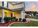 Two-story house with a beige exterior, a white garage door, and a landscaped front yard at 108 Glenspring Dr, Summerville, SC 29486