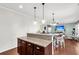 Open kitchen features a granite island and breakfast bar at 108 Glenspring Dr, Summerville, SC 29486