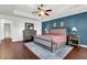 Main bedroom with king bed, hardwood floors, and blue accent wall at 108 Glenspring Dr, Summerville, SC 29486