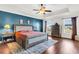 Main bedroom with a king-size bed, blue accent wall, and hardwood floors at 108 Glenspring Dr, Summerville, SC 29486