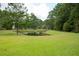 Serene pond view with lush green grass and trees at 123 Surlington Dr, Ladson, SC 29485