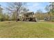 A-frame home with a large backyard and a partially covered patio at 1269 College Park Rd, Summerville, SC 29486