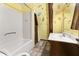 Bathroom with tub, sink, and whimsical decor at 1269 College Park Rd, Summerville, SC 29486