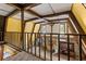 Open loft area overlooking living room with exposed wooden beams at 1269 College Park Rd, Summerville, SC 29486