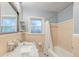 Clean bathroom with neutral tile, marble vanity, and bathtub at 1407 Fairfield Ave, Charleston, SC 29407