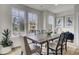 Bright dining room with large windows and a wooden table at 2008 Quiet Ibis Rd, Hanahan, SC 29410