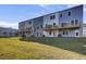 Rear view of townhouses showcasing decks and yards at 2008 Quiet Ibis Rd, Hanahan, SC 29410