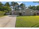 Brick ranch home with driveway, landscaped lawn, and mature trees at 313 Clearwater Dr, Goose Creek, SC 29445