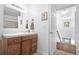 Clean bathroom with wood vanity, mirror, and access to upstairs at 3260 Cohen Hill Rd, Johns Island, SC 29455