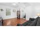 Bright bedroom with hardwood floors, window, and built-in shelving at 3260 Cohen Hill Rd, Johns Island, SC 29455