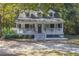 Charming yellow house with a wraparound porch and a well-manicured lawn at 3260 Cohen Hill Rd, Johns Island, SC 29455