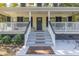 Front porch with gray steps and black door at 3260 Cohen Hill Rd, Johns Island, SC 29455