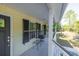 Front porch with gray flooring and black door at 3260 Cohen Hill Rd, Johns Island, SC 29455