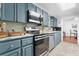 Modern kitchen with teal cabinets and stainless steel appliances at 3260 Cohen Hill Rd, Johns Island, SC 29455