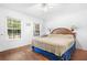 Spacious bedroom with hardwood floors, a king-size bed, and large windows at 3260 Cohen Hill Rd, Johns Island, SC 29455