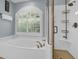 Spa-like bathroom with soaking tub, shower, and arched window at 3400 Henrietta Hartford Rd, Mount Pleasant, SC 29466