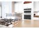 Gas cooktop with stainless steel range hood in a bright kitchen at 3400 Henrietta Hartford Rd, Mount Pleasant, SC 29466