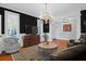 Living room with dark walls, hardwood floors, and comfy seating at 3400 Henrietta Hartford Rd, Mount Pleasant, SC 29466