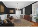 Living room with dark walls, hardwood floors, and comfy seating at 3400 Henrietta Hartford Rd, Mount Pleasant, SC 29466