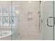 Walk-in shower with marble tile and glass enclosure at 562 Flambeau Retreat, Mount Pleasant, SC 29464