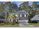 Two-story home with gray brick and white trim, featuring a front porch and attached garage at 700 Kilarney Rd, Summerville, SC 29483