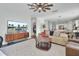 Bright living room with large TV, comfortable furniture, and hardwood floors at 700 Kilarney Rd, Summerville, SC 29483