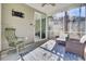 Screened porch features wicker chairs, rug, and sliding glass door at 700 Kilarney Rd, Summerville, SC 29483