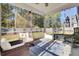 Relaxing screened porch with wicker furniture and patterned rug at 700 Kilarney Rd, Summerville, SC 29483