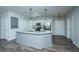 Large kitchen island with granite countertops and gray cabinets at 7201 Bowen Corner Ave, Hanahan, SC 29410