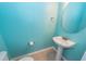 Powder room with pedestal sink and teal walls at 9044 Parlor Dr, Ladson, SC 29456