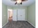 Light green bedroom with carpet flooring, ceiling fan and double doors at 9044 Parlor Dr, Ladson, SC 29456