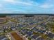 Wide shot of a residential area showing houses, roads, and undeveloped land at 104 True Blue, Summerville, SC 29486